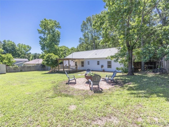 33 Glendale Acres Acres, Eclectic, AL 36024 - rear view of house with metal roof, a fire pit, and a patio