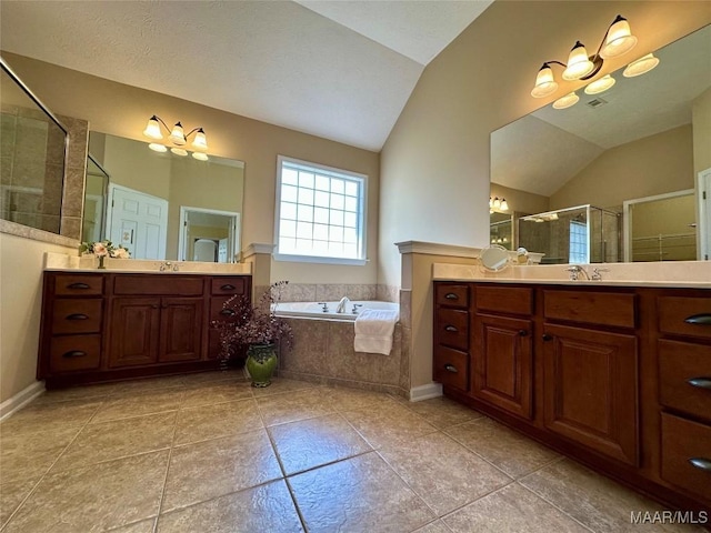 624 Stoneybrooke Way, Montgomery, AL 36117 - bathroom featuring vaulted ceiling, two vanities, a shower stall, tile patterned flooring, and a bath