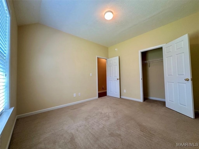624 Stoneybrooke Way, Montgomery, AL 36117 - unfurnished bedroom with carpet flooring, a closet, lofted ceiling, and baseboards