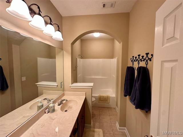 624 Stoneybrooke Way, Montgomery, AL 36117 - full bathroom featuring toilet, tile patterned flooring, vanity, shower / washtub combination, and a textured ceiling