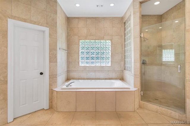 2261 Vaughn Ln, Montgomery, AL 36106 - full bath with a shower stall, a bath, tile patterned flooring, tile walls, and crown molding