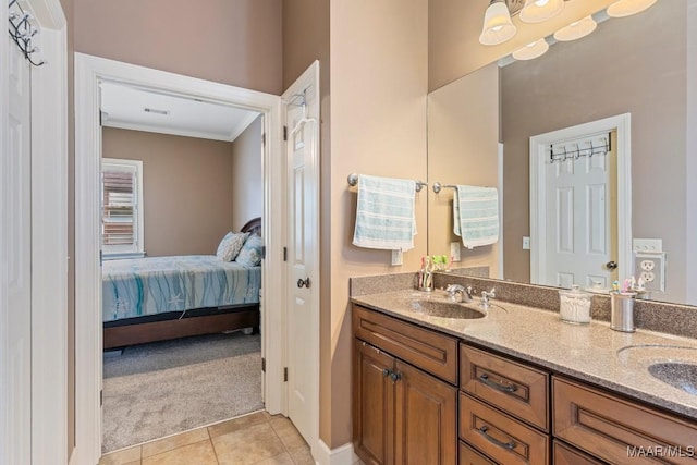 1900 Wyndgate Loop, Montgomery, AL 36117 - ensuite bathroom with crown molding, double vanity, tile patterned floors, and baseboards