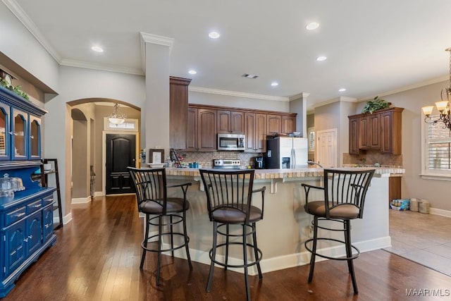 1900 Wyndgate Loop, Montgomery, AL 36117 - kitchen featuring stainless steel appliances, arched walkways, backsplash, a chandelier, and recessed lighting