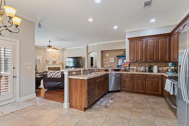 1900 Wyndgate Loop, Montgomery, AL 36117 - kitchen with appliances with stainless steel finishes, a peninsula, a sink, open floor plan, and ornamental molding