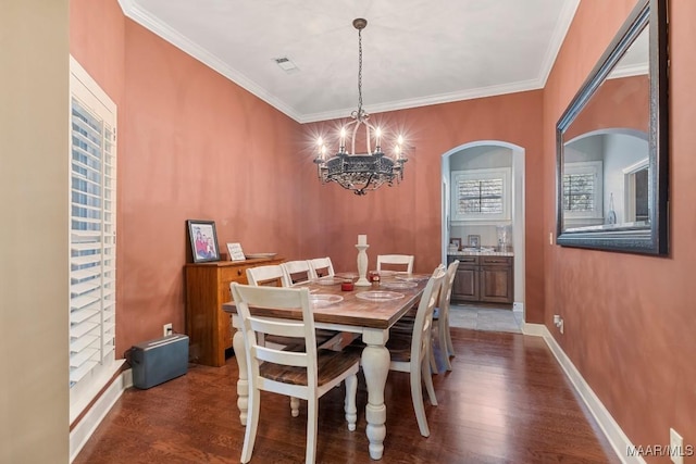 1900 Wyndgate Loop, Montgomery, AL 36117 - dining space with a chandelier, dark wood finished floors, crown molding, arched walkways, and baseboards