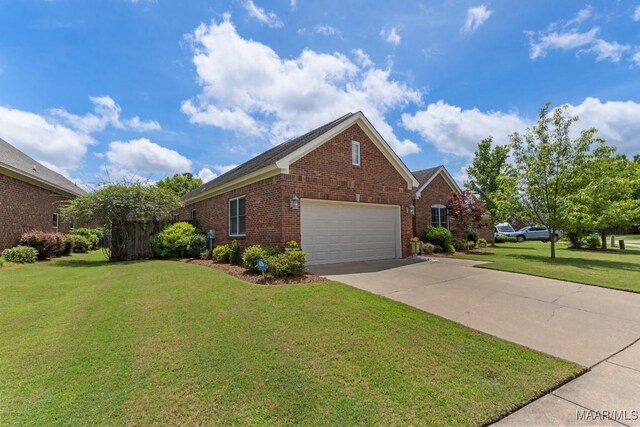 1900 Wyndgate Loop, Montgomery, AL 36117 - view of property exterior with brick siding, a garage, a lawn, and driveway