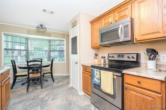 1505 Terrace Ct, Opelika, AL 36081 - kitchen with appliances with stainless steel finishes, ornamental molding, baseboards, and light stone countertops