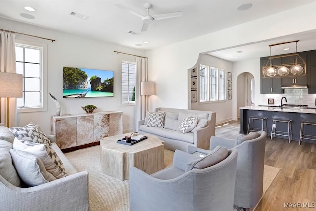 4808 Clerkenwell St, Montgomery, AL 36116 - living room featuring arched walkways, a ceiling fan, light wood finished floors, plenty of natural light, and recessed lighting