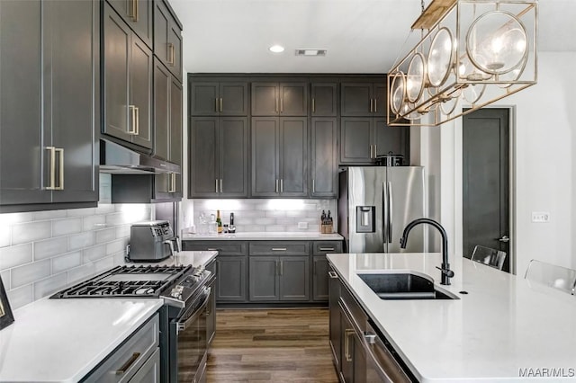 4808 Clerkenwell St, Montgomery, AL 36116 - kitchen featuring appliances with stainless steel finishes, a sink, under cabinet range hood, light countertops, and recessed lighting