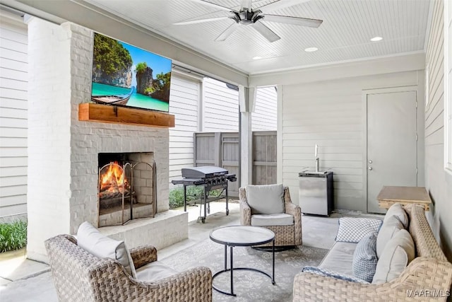 4808 Clerkenwell St, Montgomery, AL 36116 - living area featuring concrete flooring, a ceiling fan, a warm lit fireplace, and recessed lighting