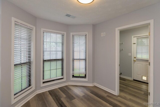 355 Hambleton Ct, Montgomery, AL 36117 - empty room with dark wood finished floors, baseboards, and a textured ceiling