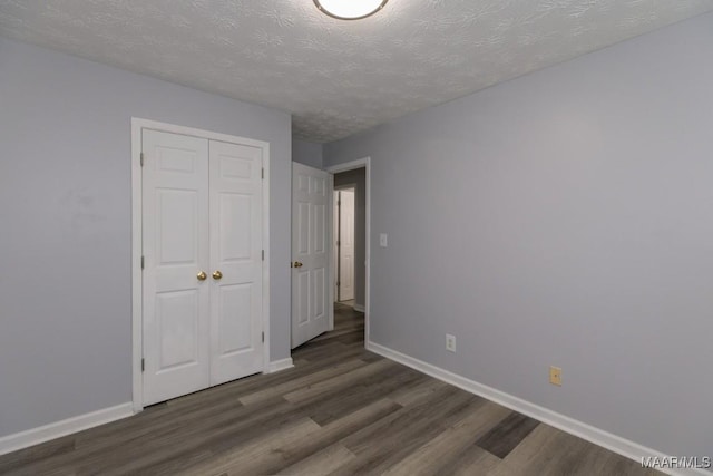 355 Hambleton Ct, Montgomery, AL 36117 - unfurnished bedroom featuring dark wood finished floors, baseboards, a closet, and a textured ceiling