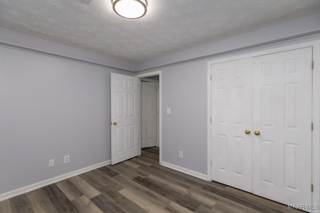 355 Hambleton Ct, Montgomery, AL 36117 - unfurnished bedroom featuring wood finished floors, baseboards, a closet, and a textured ceiling