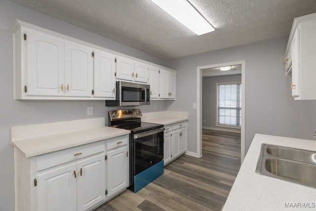 355 Hambleton Ct, Montgomery, AL 36117 - kitchen with appliances with stainless steel finishes, a sink, white cabinets, dark wood-style floors, and a textured ceiling