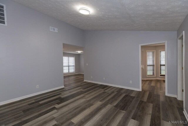 355 Hambleton Ct, Montgomery, AL 36117 - spare room featuring lofted ceiling, a textured ceiling, dark wood-style floors, and baseboards
