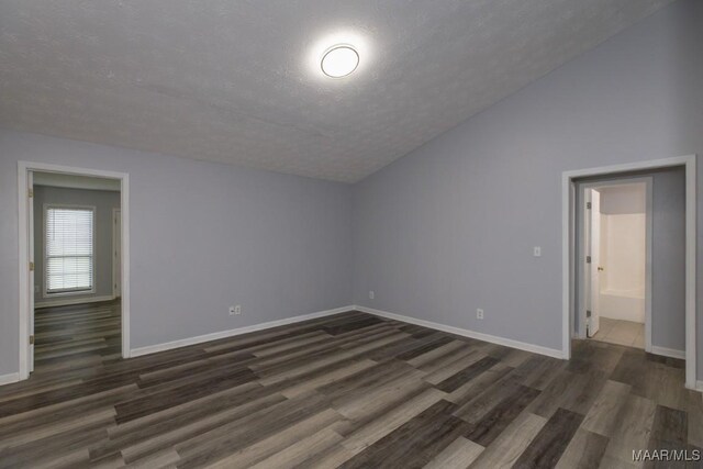355 Hambleton Ct, Montgomery, AL 36117 - additional living space with a textured ceiling, dark wood-style flooring, baseboards, and vaulted ceiling