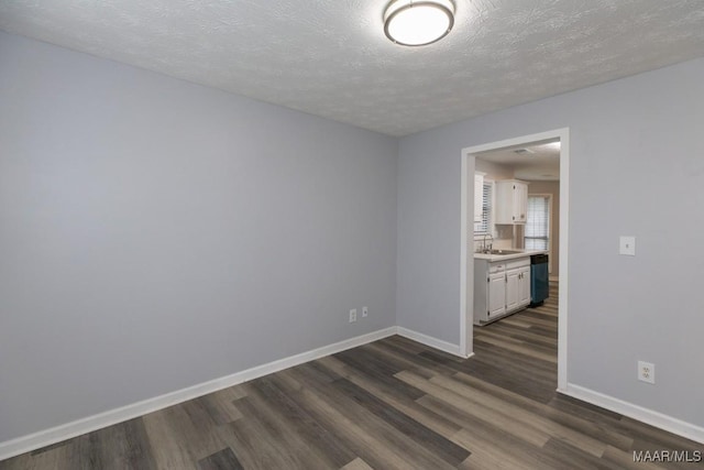 355 Hambleton Ct, Montgomery, AL 36117 - unfurnished room with dark wood finished floors, baseboards, a textured ceiling, and a sink