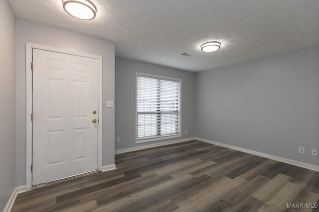 355 Hambleton Ct, Montgomery, AL 36117 - foyer with dark wood-style floors, a textured ceiling, and baseboards