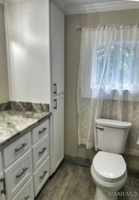 235 N Northington St, Prattville, AL 36067 - bathroom featuring vanity, toilet, and crown molding