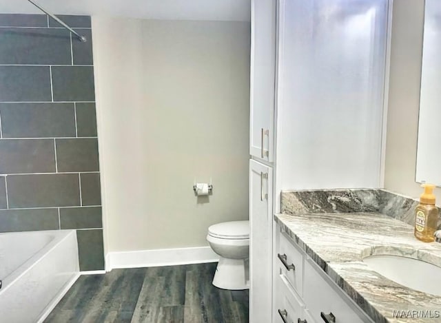 235 N Northington St, Prattville, AL 36067 - full bathroom with vanity, toilet, wood finished floors, baseboards, and  shower combination