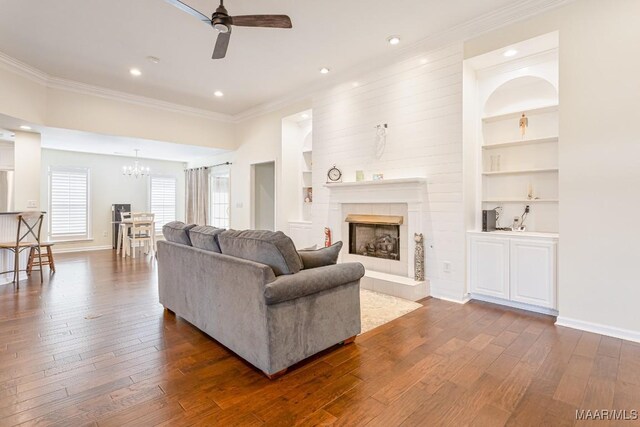 8115 Bridgewater Trce, Montgomery, AL 36117 - living area with a ceiling fan, ornamental molding, a chandelier, dark wood finished floors, and built in shelves