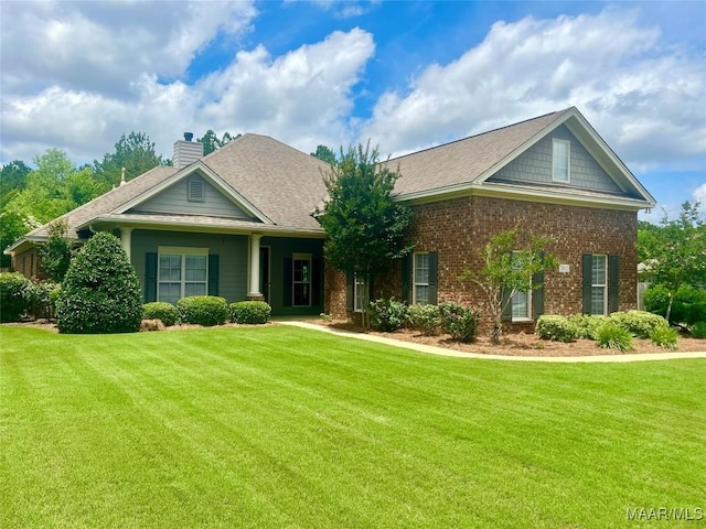 1112 Carston Point Cir, Montgomery, AL 36117 - craftsman-style house featuring a front yard, a chimney, brick siding, and a shingled roof