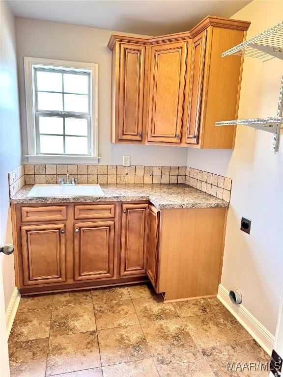 1112 Carston Point Cir, Montgomery, AL 36117 - laundry area featuring hookup for an electric dryer, cabinet space, and baseboards