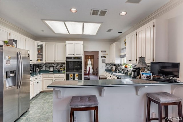 530 Old Mitylene Ct, Montgomery, AL 36117 - kitchen featuring stainless steel fridge with ice dispenser, a peninsula, a sink, tasteful backsplash, and recessed lighting