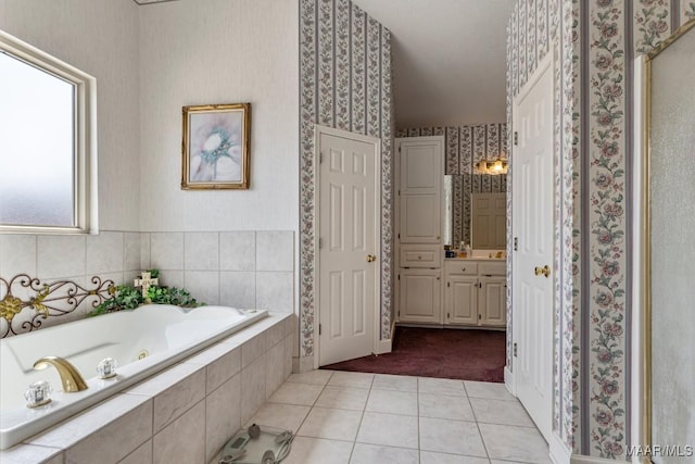 530 Old Mitylene Ct, Montgomery, AL 36117 - bathroom with wallpapered walls, tile patterned flooring, a whirlpool tub, vanity, and a closet
