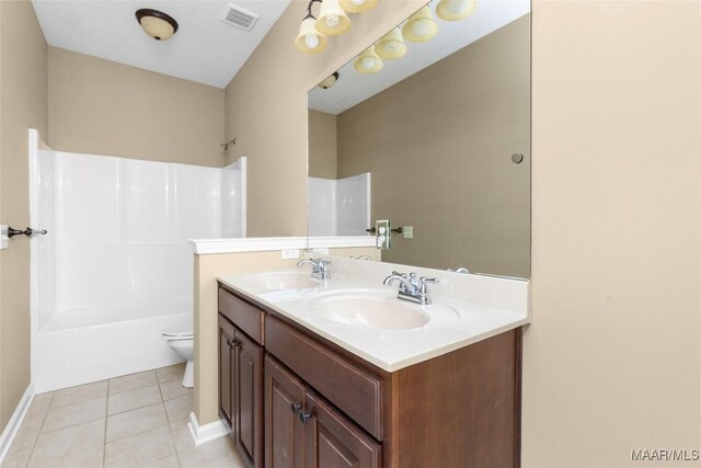 9000 Finsburry Ct, Montgomery, AL 36117 - bathroom featuring double vanity, toilet, tub / shower combination, tile patterned flooring, and baseboards