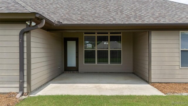9000 Finsburry Ct, Montgomery, AL 36117 - view of exterior entry with roof with shingles and a patio area