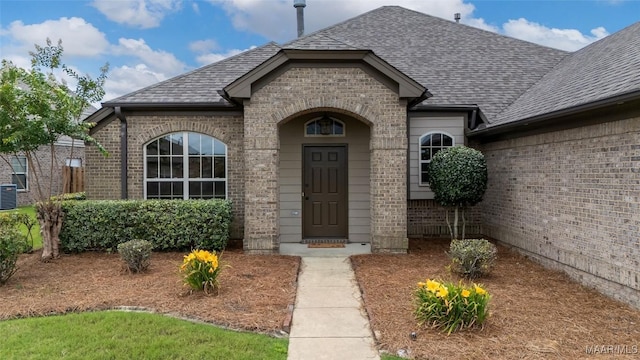 9000 Finsburry Ct, Montgomery, AL 36117 - view of exterior entry featuring brick siding, a shingled roof, and central air condition unit
