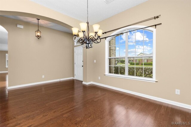 9000 Finsburry Ct, Montgomery, AL 36117 - empty room with dark wood finished floors, a chandelier, baseboards, and arched walkways