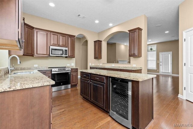 9000 Finsburry Ct, Montgomery, AL 36117 - kitchen with appliances with stainless steel finishes, beverage cooler, a sink, light wood-style floors, and recessed lighting