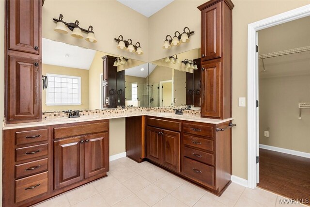9000 Finsburry Ct, Montgomery, AL 36117 - full bathroom with vanity, tile patterned floors, a walk in closet, and baseboards