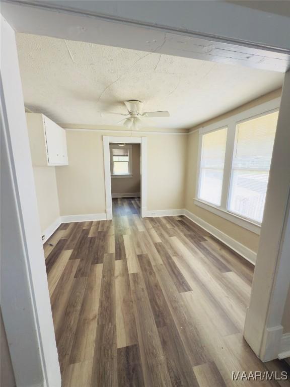 2829 Highland Ave, Montgomery, AL 36107 - spare room featuring baseboards, wood finished floors, a textured ceiling, and a ceiling fan