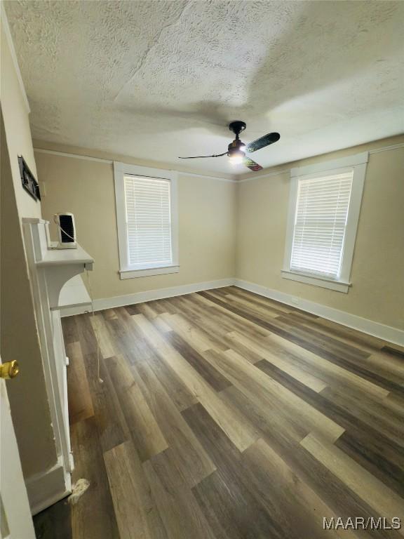 2829 Highland Ave, Montgomery, AL 36107 - unfurnished bedroom featuring a textured ceiling, wood finished floors, baseboards, and ceiling fan