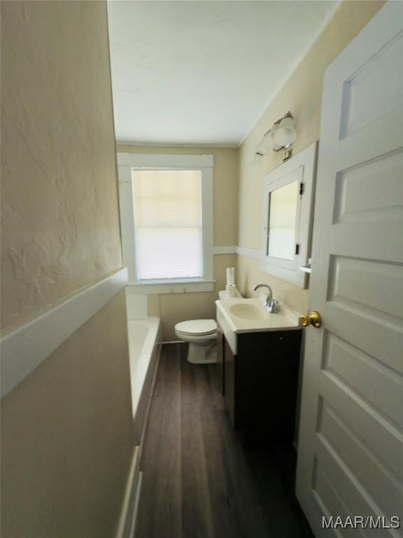 2829 Highland Ave, Montgomery, AL 36107 - full bath with wood finished floors, vanity, toilet, and a tub to relax in