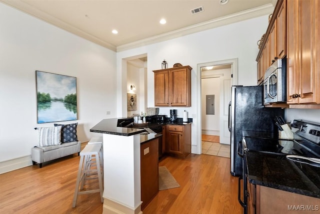 48 Stoneview Summit Ct Unit 2505, Dadeville, AL 36853 - kitchen featuring stainless steel microwave, black electric range oven, a peninsula, a kitchen bar, and brown cabinetry