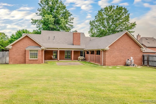 3049 Fieldcrest Dr, Montgomery, AL 36106 - view of front of house with a chimney, brick siding, a patio area, and a shingled roof