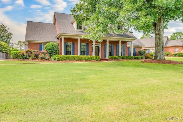 3049 Fieldcrest Dr, Montgomery, AL 36106 - cape cod home with a front lawn, brick siding, roof with shingles, and covered porch