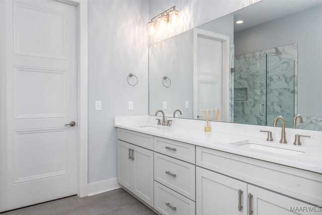 7175 Fain Park Loop, Montgomery, AL 36117 - bathroom with double vanity, a marble finish shower, tile patterned floors, and baseboards