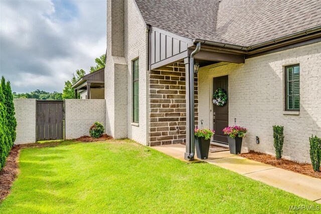 7175 Fain Park Loop, Montgomery, AL 36117 - doorway to property with a shingled roof, brick siding, and a gate