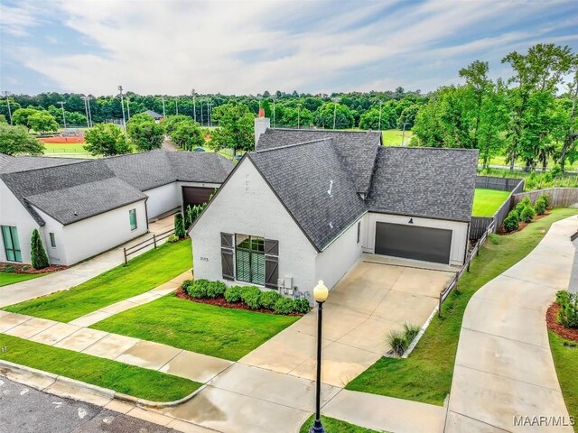 7175 Fain Park Loop, Montgomery, AL 36117 - view of front of house with roof with shingles, an attached garage, driveway, stucco siding, and a chimney