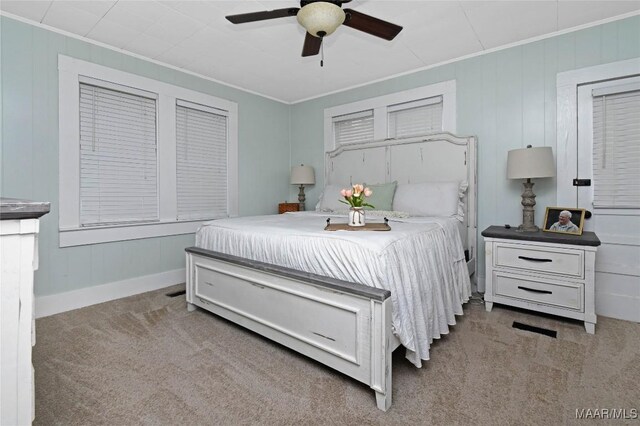 8099 County Road 59, Verbena, AL 36091 - carpeted bedroom with ornamental molding, baseboards, ceiling fan, and wooden walls