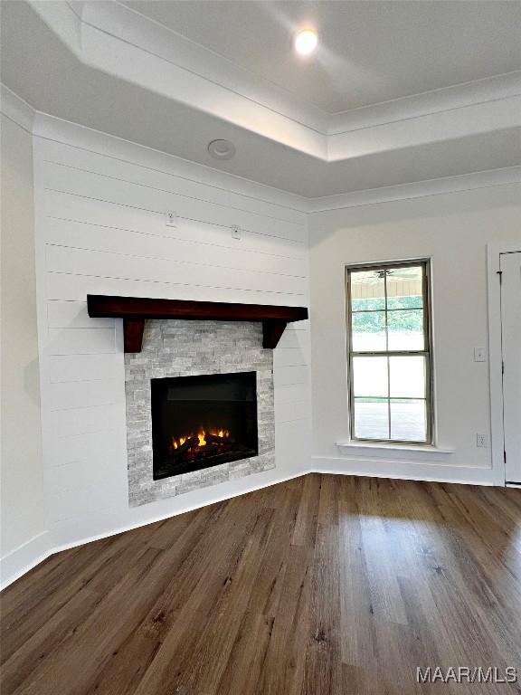 40 Serene Ln, Wetumpka, AL 36093 - unfurnished living room featuring a raised ceiling, wood finished floors, a fireplace, and crown molding