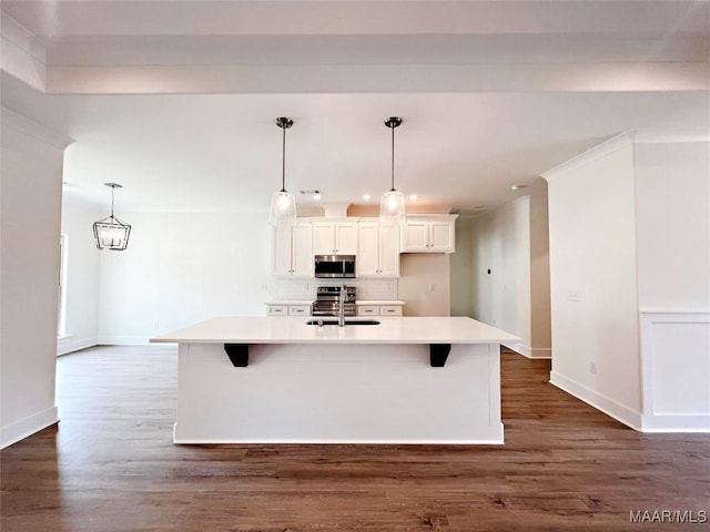 40 Serene Ln, Wetumpka, AL 36093 - kitchen with appliances with stainless steel finishes, backsplash, light countertops, a kitchen island with sink, and white cabinetry