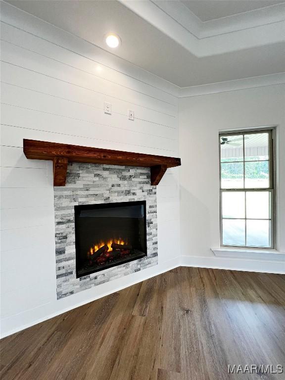 60 Serene Ln, Wetumpka, AL 36093 - unfurnished living room with wood finished floors, a glass covered fireplace, a tray ceiling, and crown molding