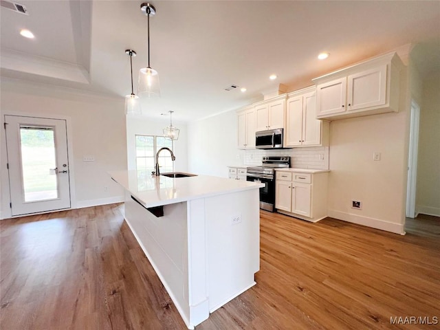 60 Serene Ln, Wetumpka, AL 36093 - kitchen with appliances with stainless steel finishes, light wood finished floors, backsplash, white cabinetry, and recessed lighting