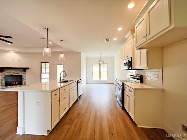 60 Serene Ln, Wetumpka, AL 36093 - kitchen with stainless steel appliances, light wood-style flooring, light countertops, open floor plan, and recessed lighting